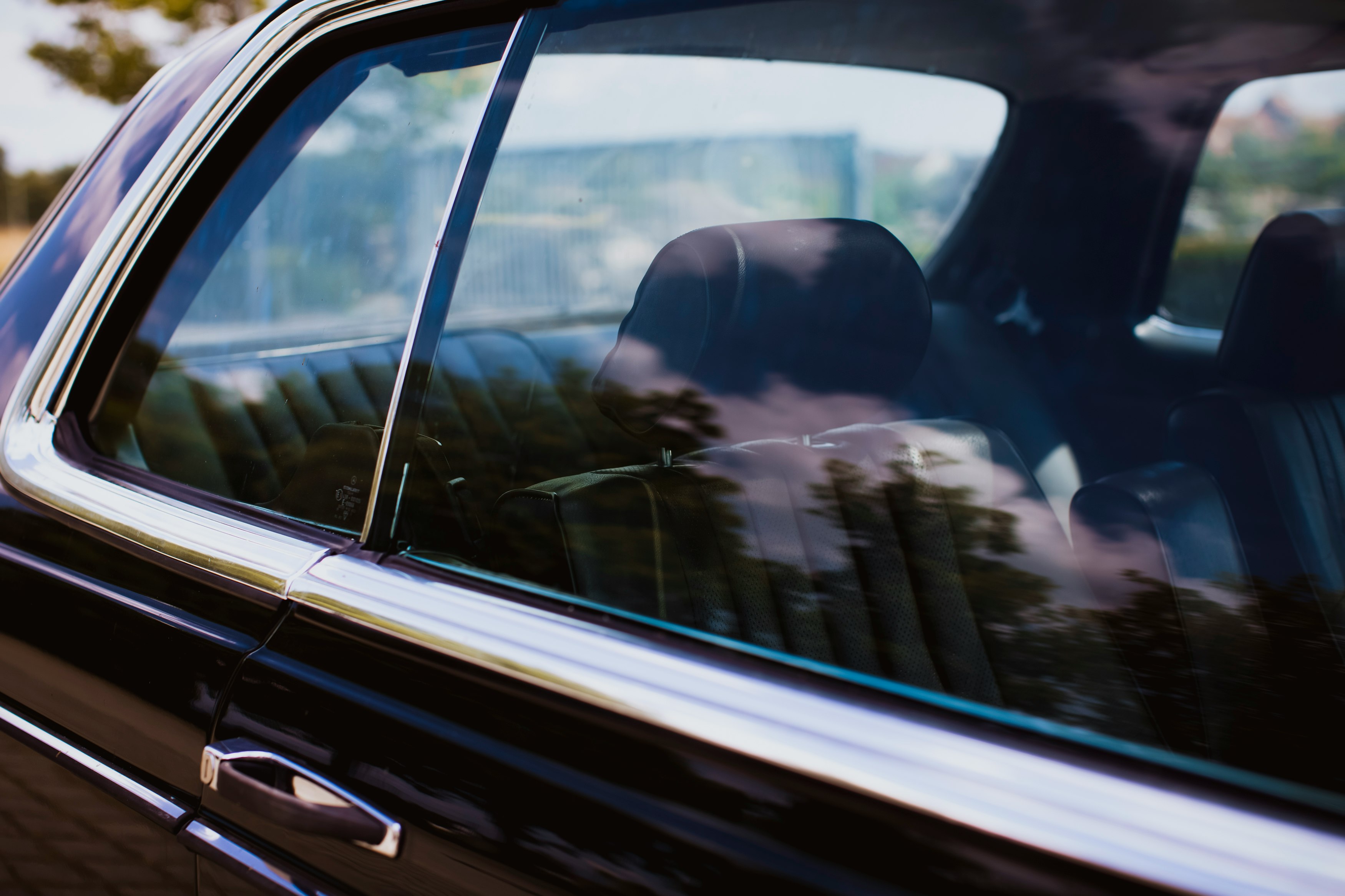 man in black jacket driving car